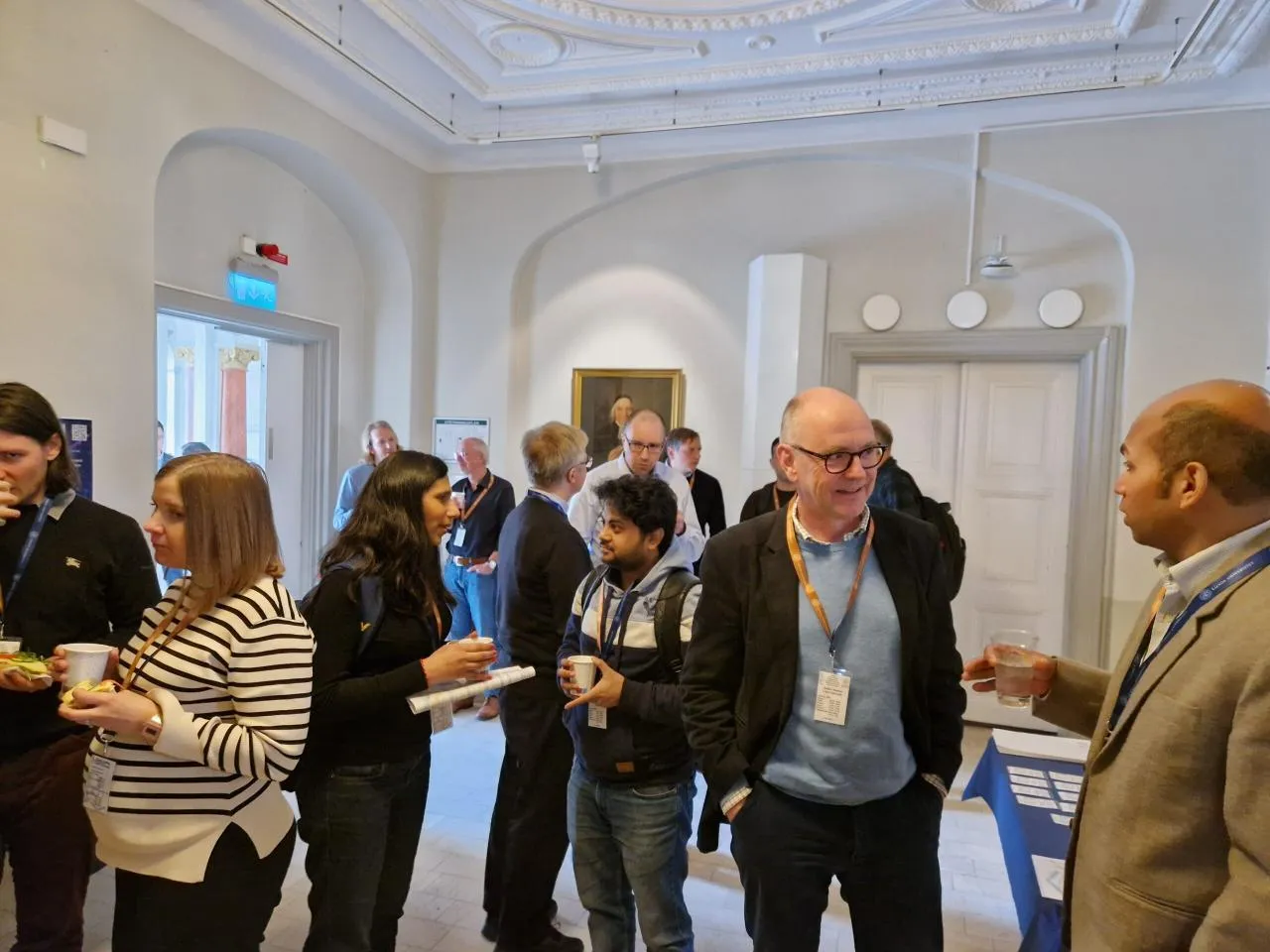 People are mingling at a conference. Photo.
